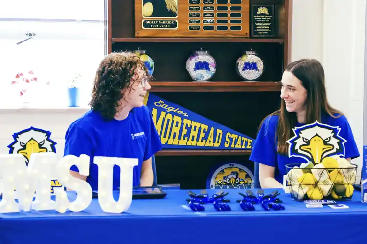 Students at an info table in the advising center