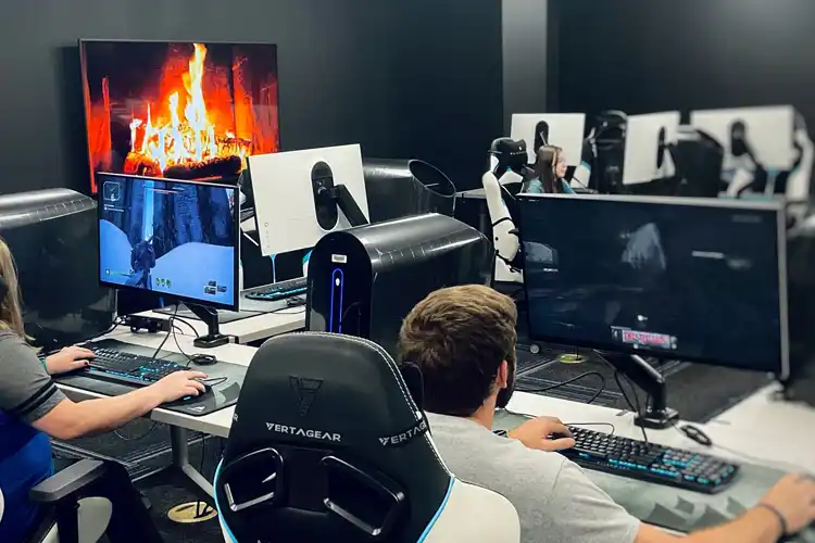 Students playing video games in the esports lounge