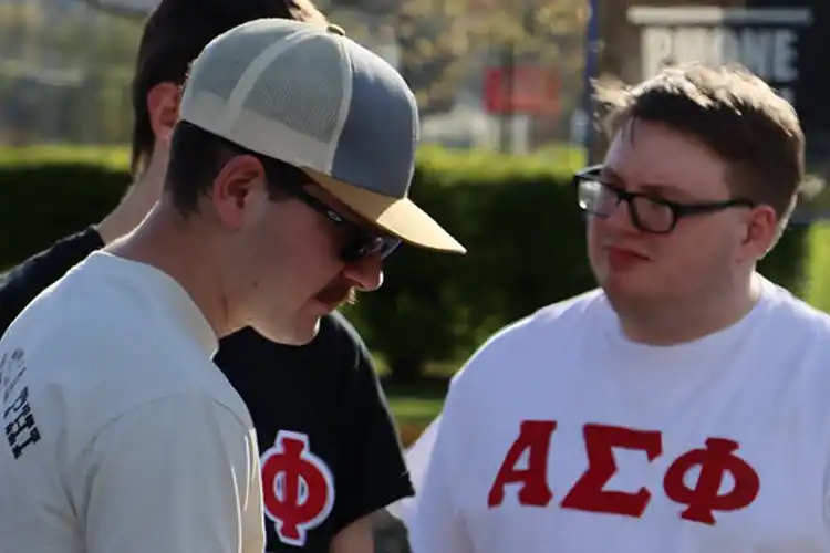 Fraternity members grilling food