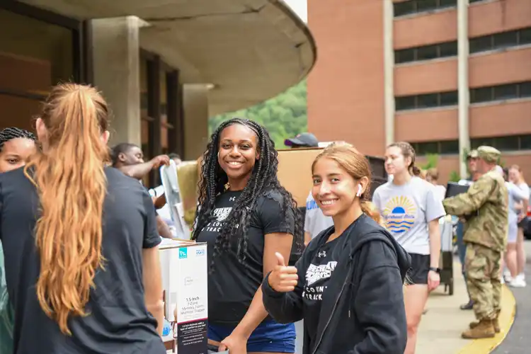 3 students with boxing moving into residence hall