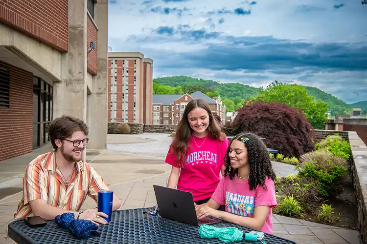 Students on laptop on patio