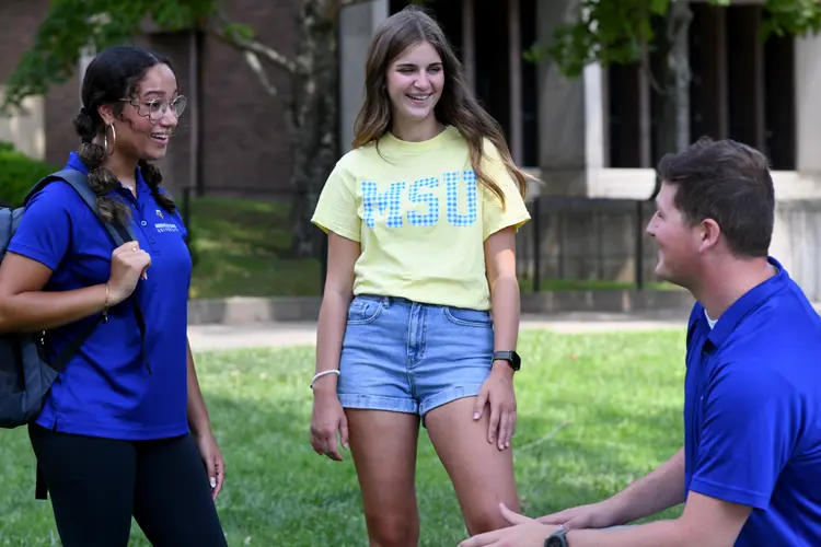 three students talking near Ginger Hall