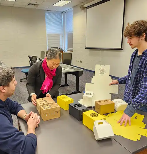 MSU student and professor building a mushroom box.