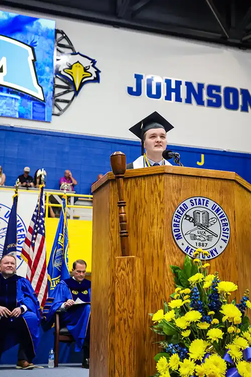 Ryan Holderby at the podium speaking during Spring 2026 Commencement.