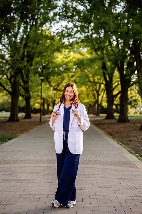 Picture of Hannah Daniels Lovely in physician's assistant uniform.