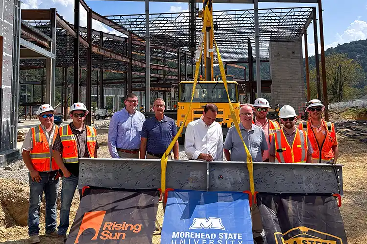 MSU President and administration signing construction beam.