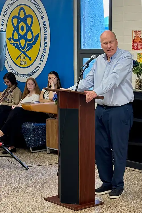 Dr. Joe Craft speaking at a podium to Craft Academy students.