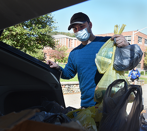 Veteran Logan Hester loads donated items into a car.